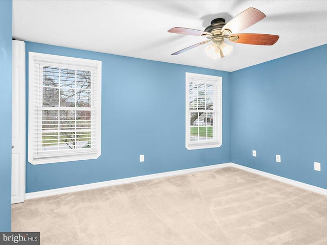 carpeted empty room featuring ceiling fan