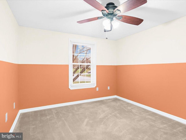 carpeted empty room featuring ceiling fan