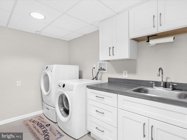 washroom featuring tile patterned flooring, cabinets, sink, and washing machine and clothes dryer