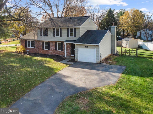 view of front of house featuring a storage unit, a garage, and a front lawn