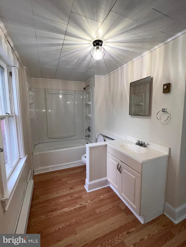 full bathroom featuring hardwood / wood-style flooring, vanity, toilet, and shower / washtub combination