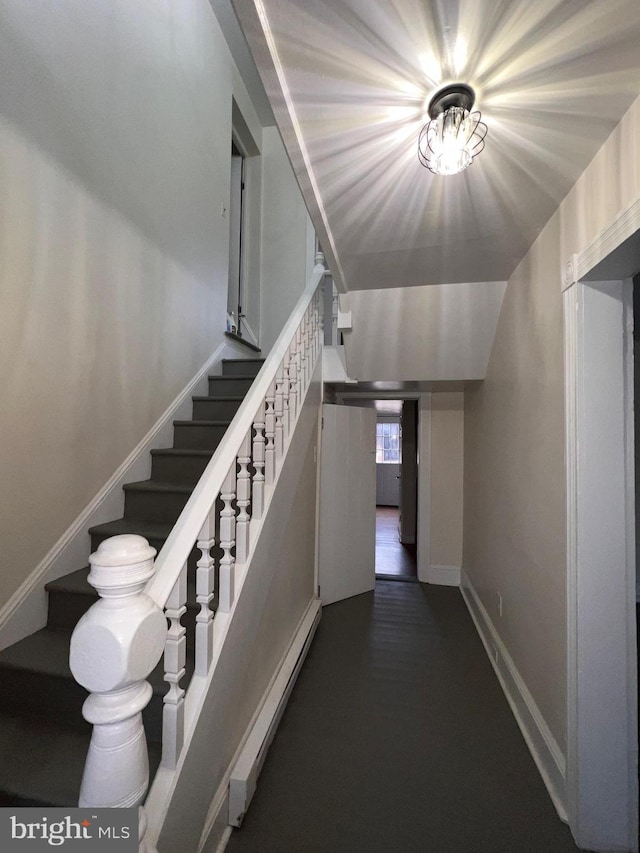 stairs with vaulted ceiling and baseboard heating