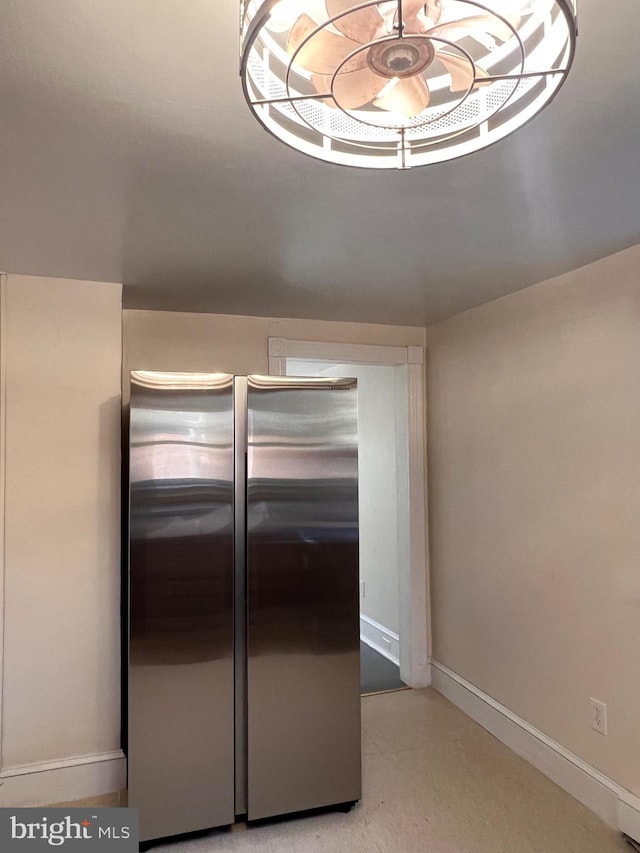 kitchen featuring stainless steel fridge and light carpet