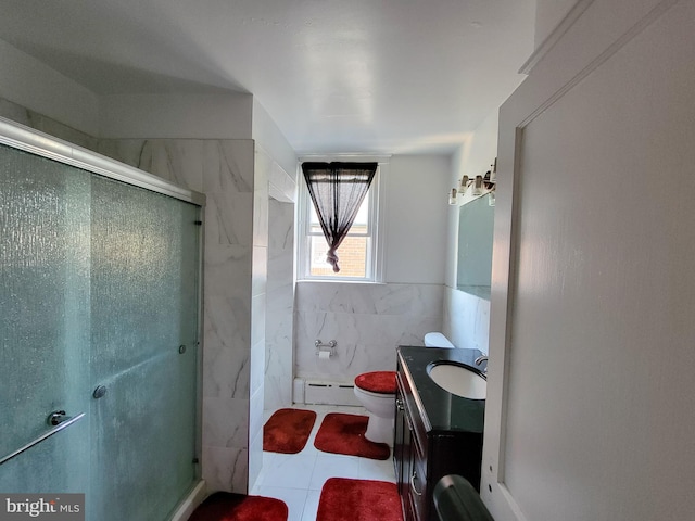 bathroom with tile patterned flooring, vanity, an enclosed shower, and a baseboard heating unit