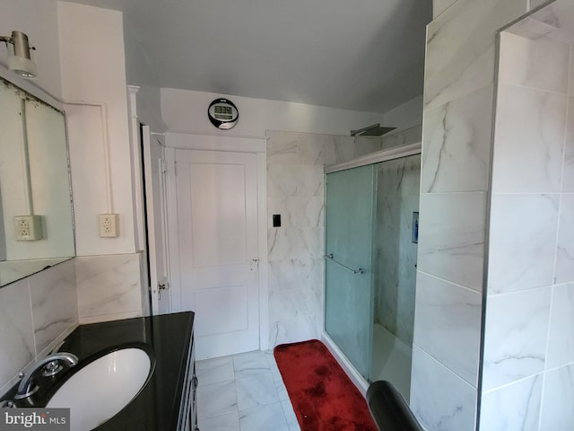 bathroom featuring tile walls, vanity, and an enclosed shower