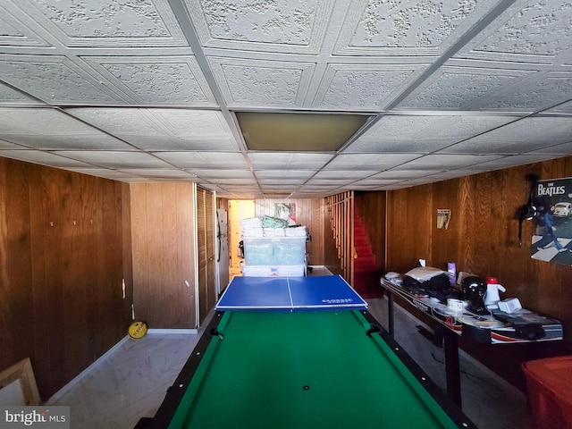 recreation room with wood walls and pool table