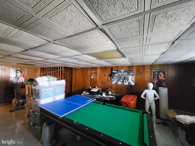 game room featuring pool table and wood walls