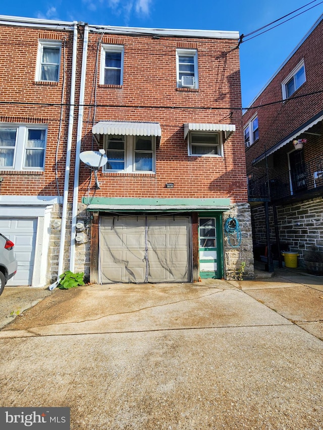 back of property with a garage