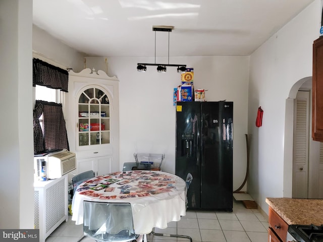 dining room with light tile patterned floors and radiator