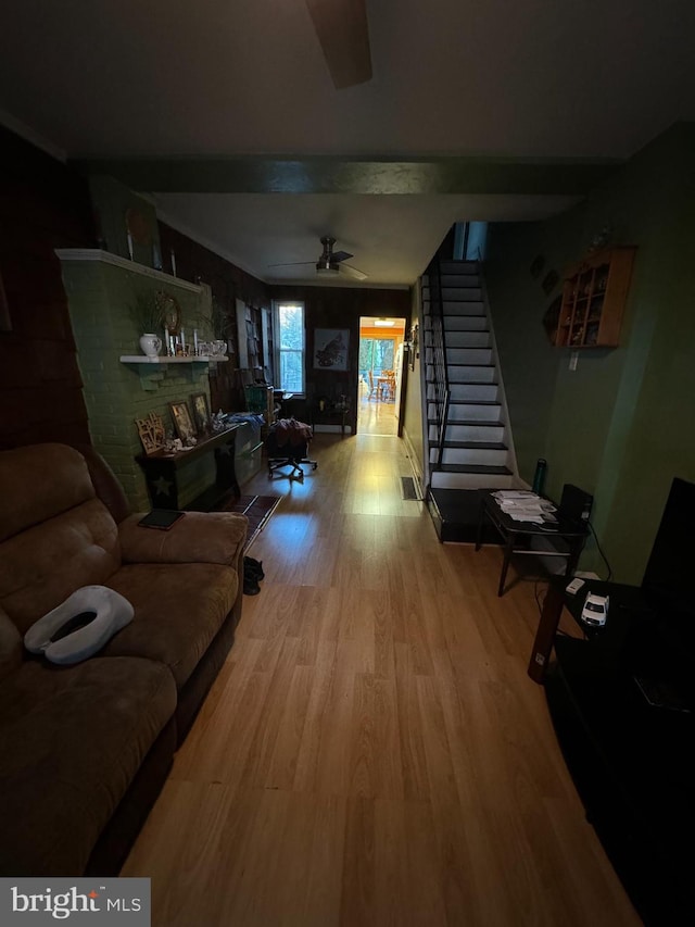 living room featuring ceiling fan and wood-type flooring