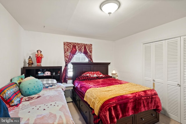 bedroom with light carpet and a closet