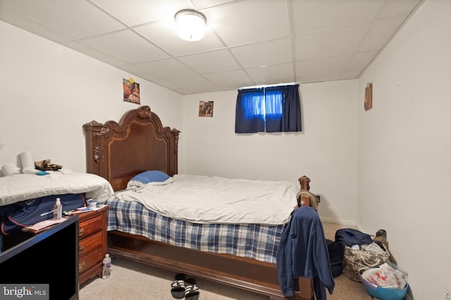 carpeted bedroom with a drop ceiling