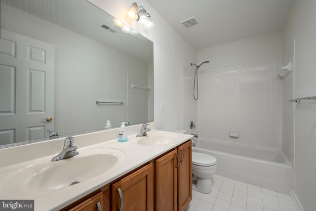 full bathroom featuring tile patterned floors, vanity, toilet, and tiled shower / bath combo