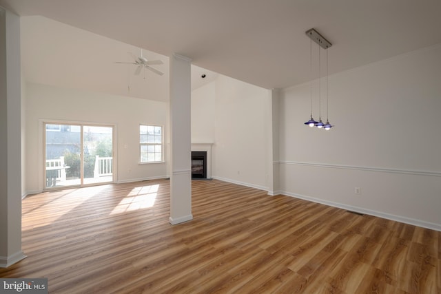 unfurnished living room featuring ceiling fan, high vaulted ceiling, and wood-type flooring