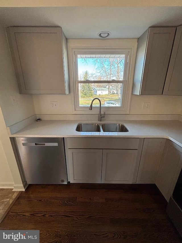 kitchen with dishwasher, dark hardwood / wood-style floors, and sink