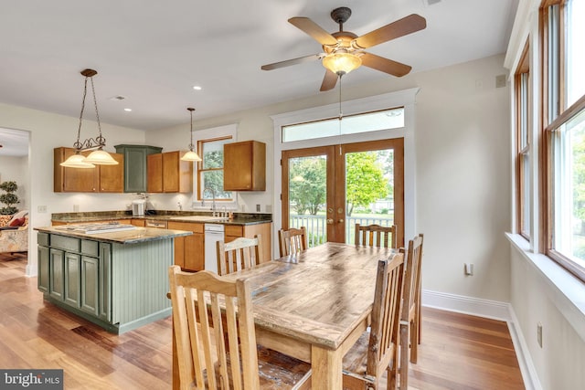 dining area featuring a wealth of natural light, french doors, ceiling fan, and light wood-type flooring