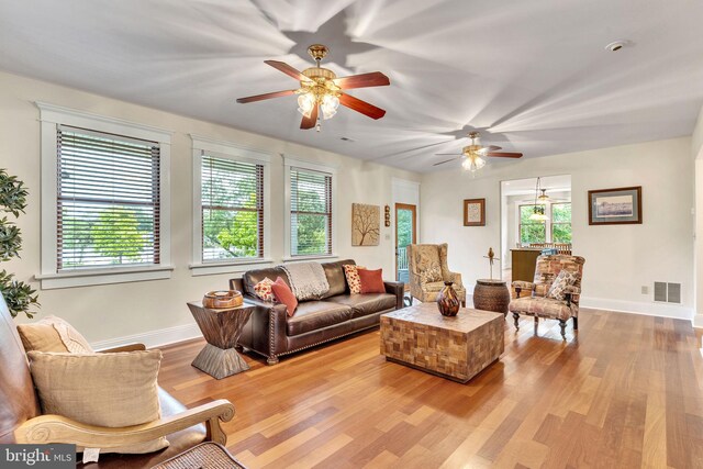 living room featuring light wood-type flooring and ceiling fan