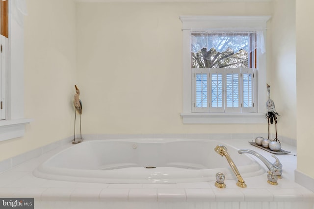 bathroom featuring tiled tub