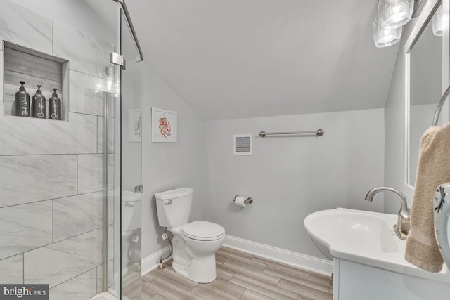 bathroom with walk in shower, vanity, vaulted ceiling, wood-type flooring, and toilet