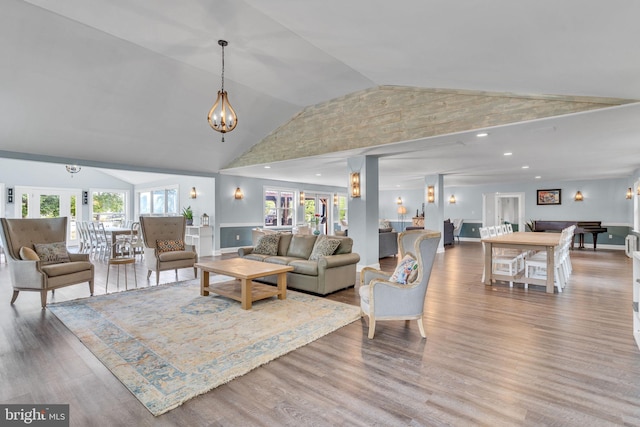 living room with wood-type flooring and high vaulted ceiling