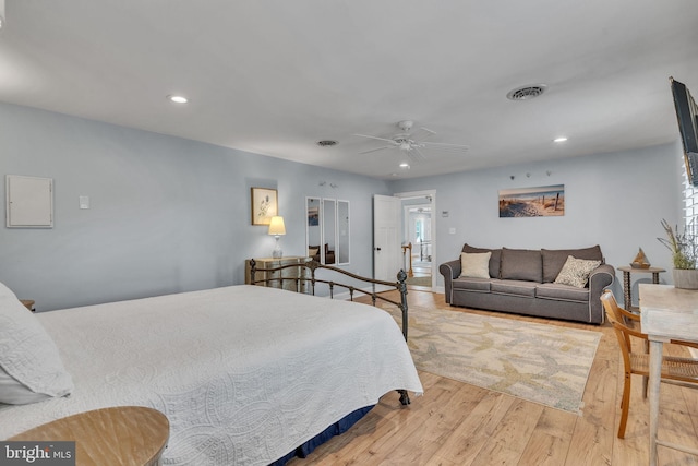 bedroom with ceiling fan and light hardwood / wood-style flooring