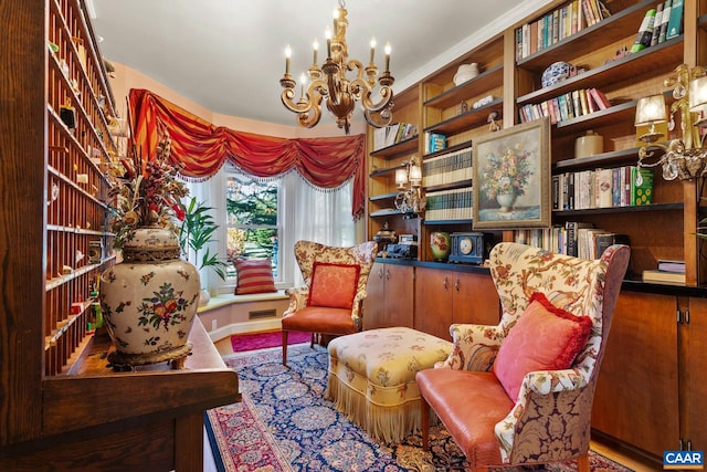 living area featuring a chandelier and ornamental molding