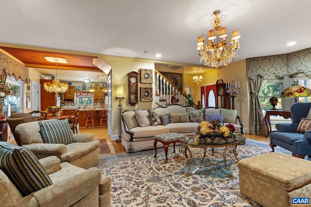 living room with light hardwood / wood-style floors and a notable chandelier