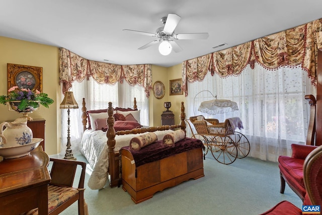 bedroom with ceiling fan and light carpet