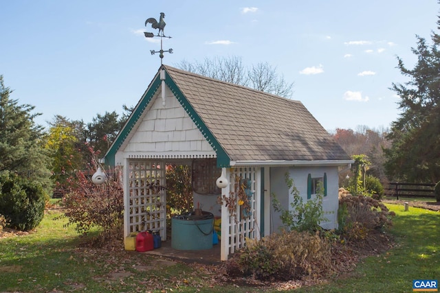 view of property exterior with a yard and an outbuilding