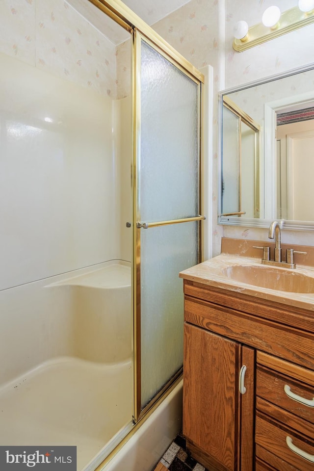 bathroom with combined bath / shower with glass door and vanity