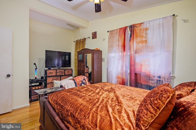 bedroom featuring ceiling fan and light hardwood / wood-style flooring