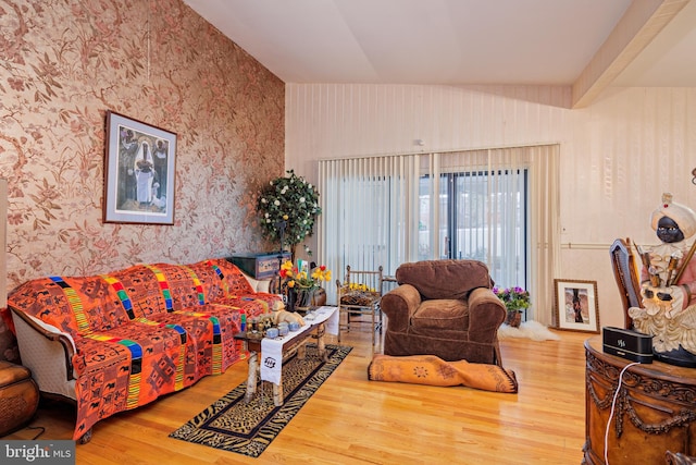 living room with wood-type flooring and vaulted ceiling