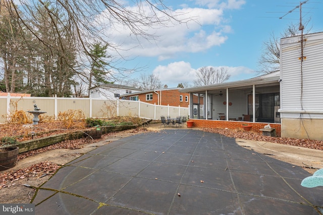 exterior space with a sunroom and a patio area