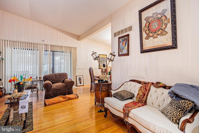 living room with hardwood / wood-style floors and beam ceiling