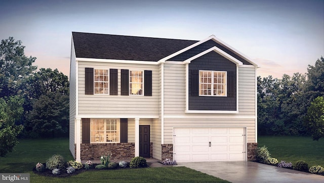 view of front of home with a yard and a garage