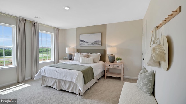 bedroom featuring light carpet