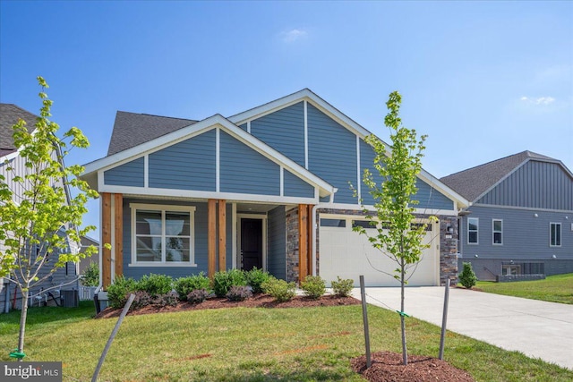 view of front of home with a garage, a front lawn, and cooling unit