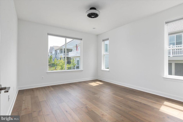 unfurnished room with hardwood / wood-style floors