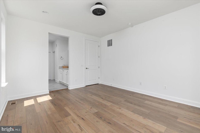 spare room featuring light wood-type flooring