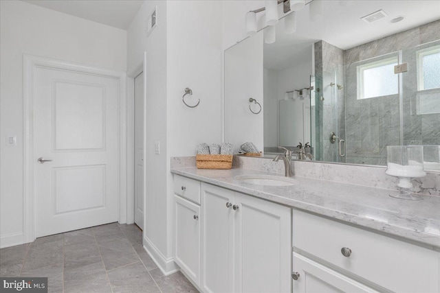 bathroom featuring vanity and an enclosed shower