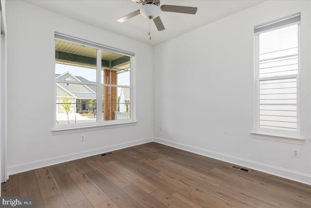 spare room featuring dark hardwood / wood-style flooring and ceiling fan