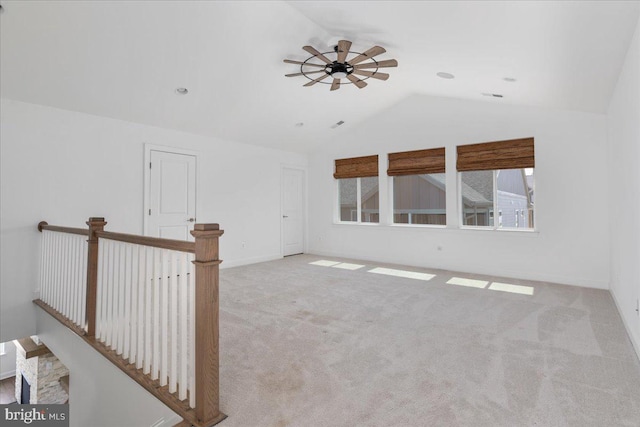 unfurnished room with ceiling fan, light carpet, and vaulted ceiling