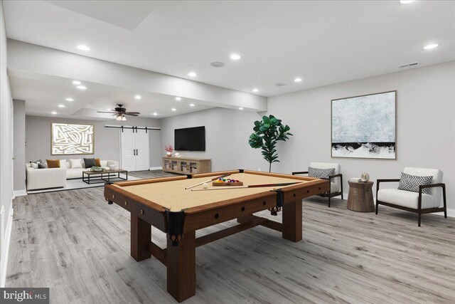 playroom with ceiling fan, light wood-type flooring, a barn door, and pool table