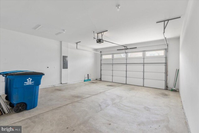 garage featuring electric panel and a garage door opener