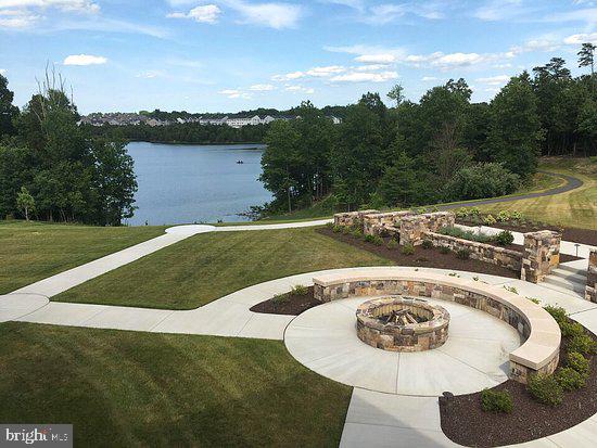 property view of water featuring a fire pit