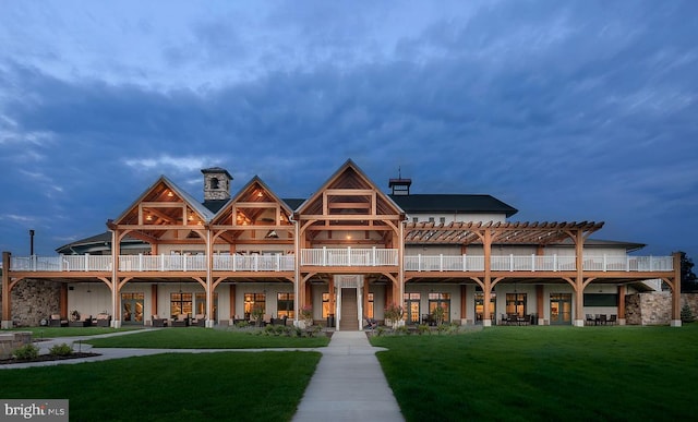 view of front of home featuring a front yard and a pergola