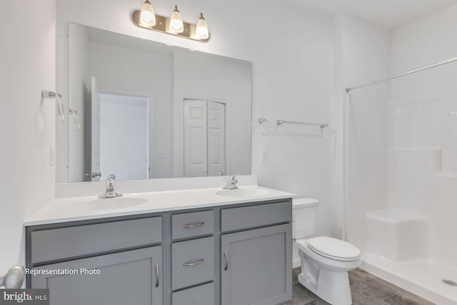 bathroom with vanity, toilet, and walk in shower