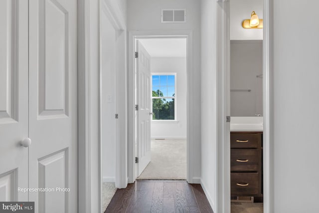 hall with dark hardwood / wood-style flooring