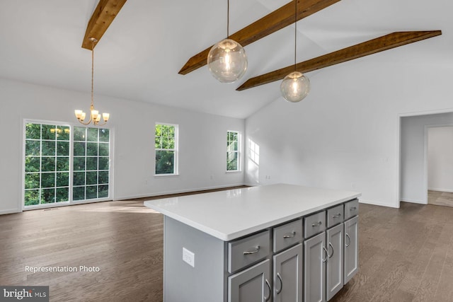 kitchen featuring pendant lighting, a kitchen island, dark hardwood / wood-style flooring, and gray cabinets