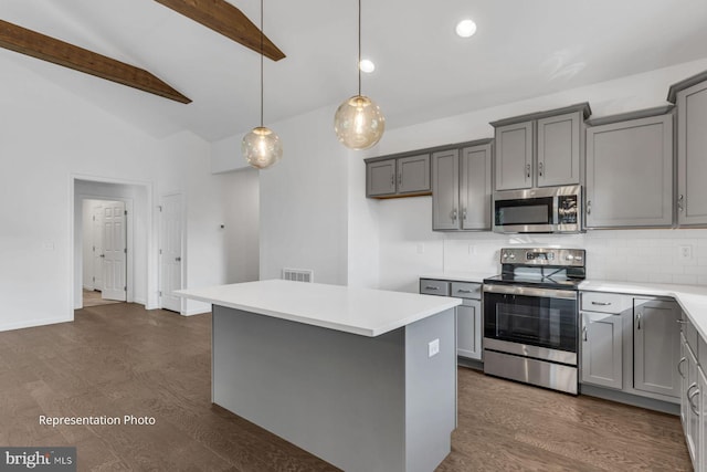 kitchen featuring dark hardwood / wood-style flooring, vaulted ceiling with beams, stainless steel appliances, and gray cabinets